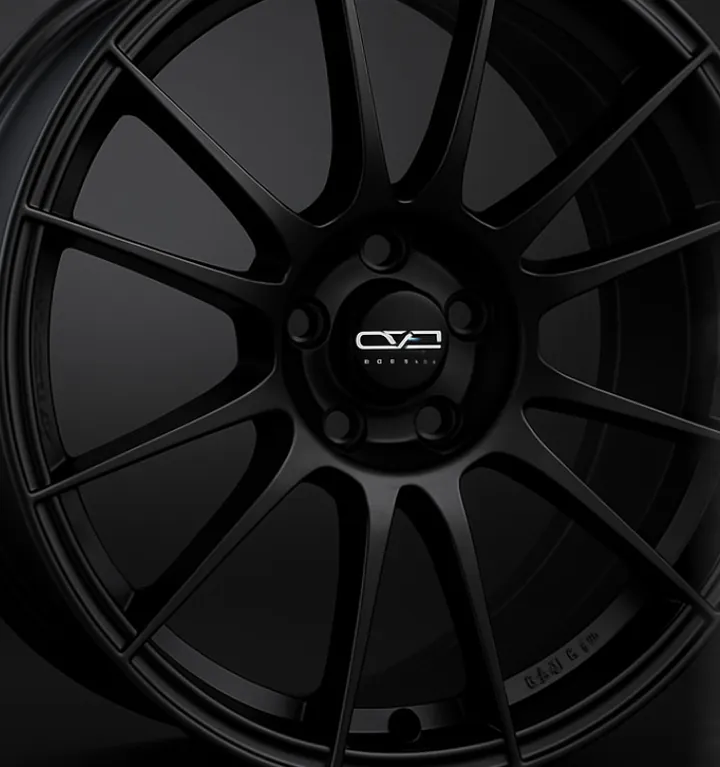 Before: a black OZ wheel from the front, a plain product photo on a dark background