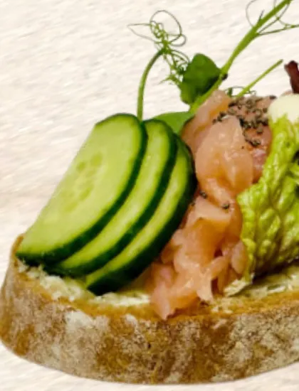 Before: an open sandwich with salmon and cucumber in an everyday photo