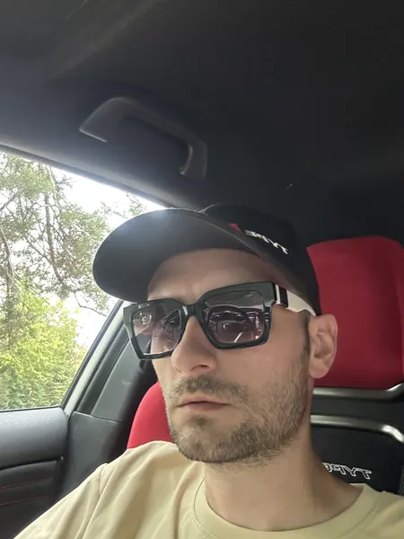 Before: an ordinary selfie of a man in a cap and sunglasses behind the wheel