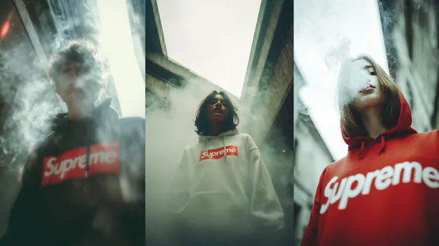Urban street style: three figures in hoodies, shot from a low angle with smoke