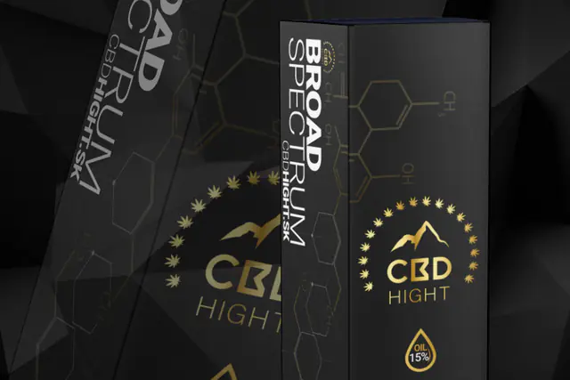 Black CBD oil boxes with a gold logo and a molecule