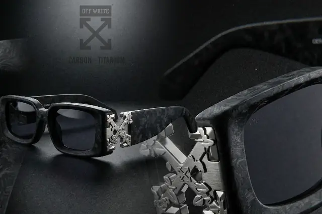 Concept: black carbon sunglasses with metal arrows on the temples